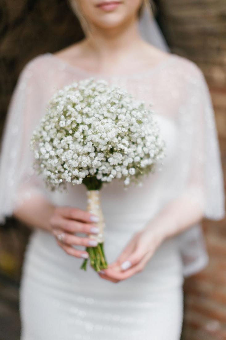 A bride holding a white bouquet